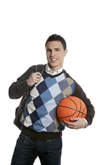 Happy young boy student with basketball ball