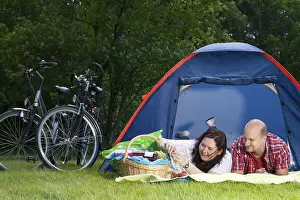 Happy young couple is relaxing on a camping