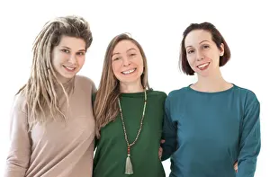 Happy young women smiling after meditating against white wall during yoga session