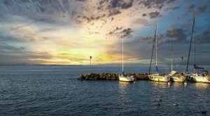 Harbour at Yvoire on Lake Leman during sunset with boats and serene waters in Haute Savoie
