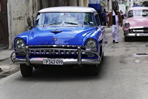 Havana, Cuba, Central America, A blue vintage car parked on a city street
