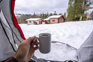 Having a coffee in a cup inside a tent on a winter morning