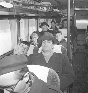 Having a nap in the 1950s. A man has fallen asleep during a bus ride