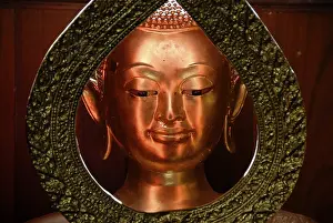 Head of a golden Buddha figure seen through a metal ring Wat Yai Chai Mongkol Ayutthaya Thailand