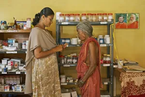Health workers of NGO Chinmaya Organization of Rural Development CORD giving medicines