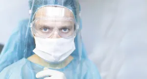 Healthcare worker in protective gear including mask and goggles