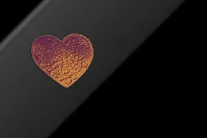 Heart shaped object amid pencil shavings