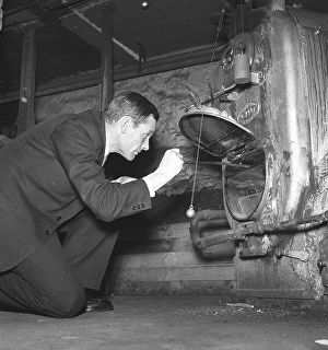 Heating in the 1940s. A man in the basement of his boiler