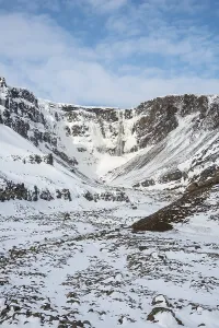 Hengifoss Waterfall, snowy landscape with river Hengifossa