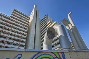 High-rise building with concrete balconies and ventilation pipes