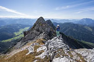 Hiker with climbing helmet on a hiking trail