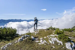 Hiker above the clouds, looking into the distance