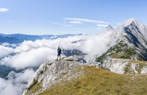 Hiker above the clouds, looking into the distance