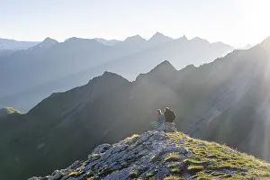 Hiker enjoying the mountain panorama in the morning