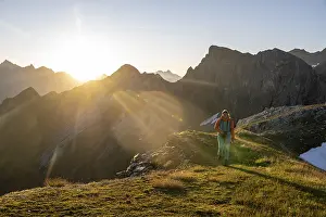 Hiker enjoying the mountain panorama in the morning