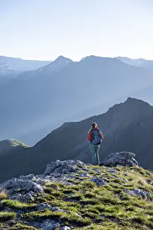 Hiker enjoying the mountain panorama in the morning