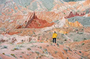 Hiker in front of eroded mountain landscape