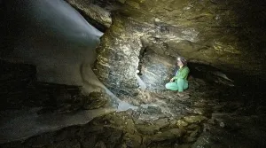 Hiker explores Obstans ice cave in Alta Pusteria