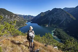 Hiker on hiking trail, view of Plansee