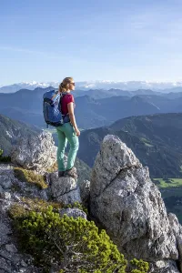 Hiker looking over green mountain landscape