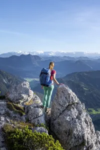 Hiker looking over green mountain landscape