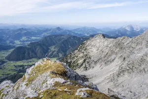 Hiker looking over landscape, green mountain landscape