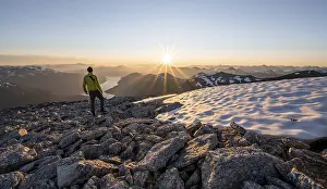 Hiker looking into the sunset, sun star