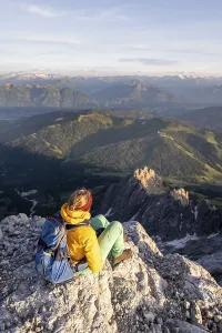 Hiker looking down into the valley from the Hochkoenig