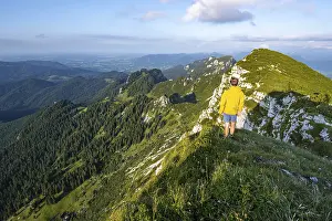 Hiker standing at a rocky cliff