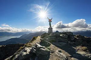 Hiker stretches out his arms in the air