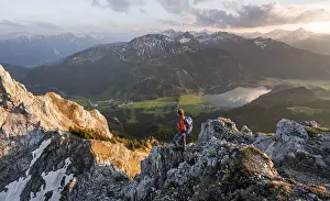 Hiker at the summit of Schartschrofen at sunset