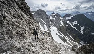 Hiker and woman descending rocky terrain