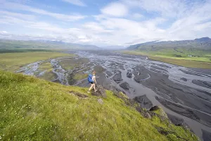 Hiker, Young woman on a hill, view over alluvial land