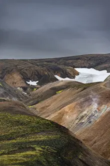 Framed Print : Hikers on colourful rhyolite mountains with remnants of snow