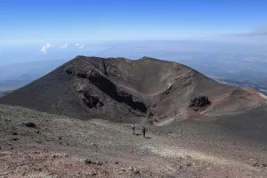 Hikers in the crater landscape of the volcano Etna