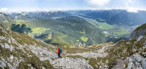 Hikers descending, Inn valley and mountain landscape