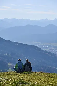 Two hikers rest on the summit of Sonntratn