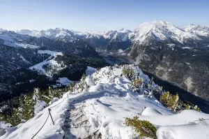 Hiking trail on the snow-covered summit of the Jenner with viewing platform in autumn