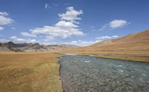 Hills with yellow meadows and river Kol Suu