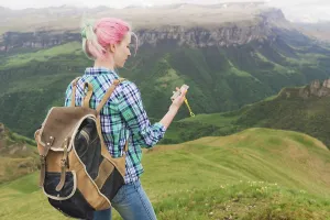 A hipster girl traveled with a blogger in a plaid shirt