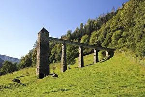 Historic aqueduct surrounded by green landscape in Freiburg