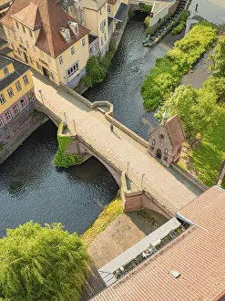 A historic bridge over a quiet river in a picturesque town