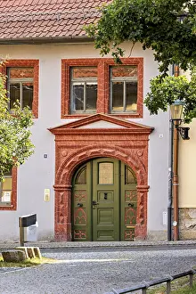 Framed Print : Historic building facade with green door and decorative red stone decorations Framed Print : Historic building facade with green door and decorative red stone decorations
