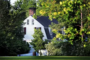 A historic building surrounded by lush trees in Colonial Williamsburg