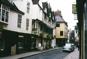 Historic buildings, people and cars on the street, Stonegate, York, Yorkshire, England in 1963