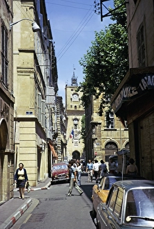 Historic buildings on the street in the city centre of Aix en Provence, France 1974 with the tower of the town hall in front of it