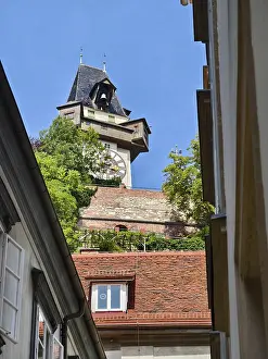Historic clock tower towers over rooftops