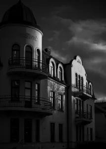 Historic European building in black and white with dramatic shadows and cloudy sky in Helsingborg