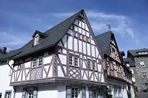Historic half-timbered house against a clear blue sky in an urban setting