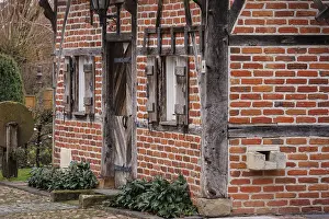 Historic half-timbered house with wooden doors and small windows